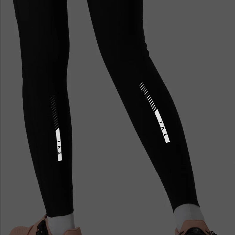 Black leggings with reflective stripes on a gray background