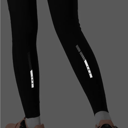 Black leggings with reflective stripes on a gray background