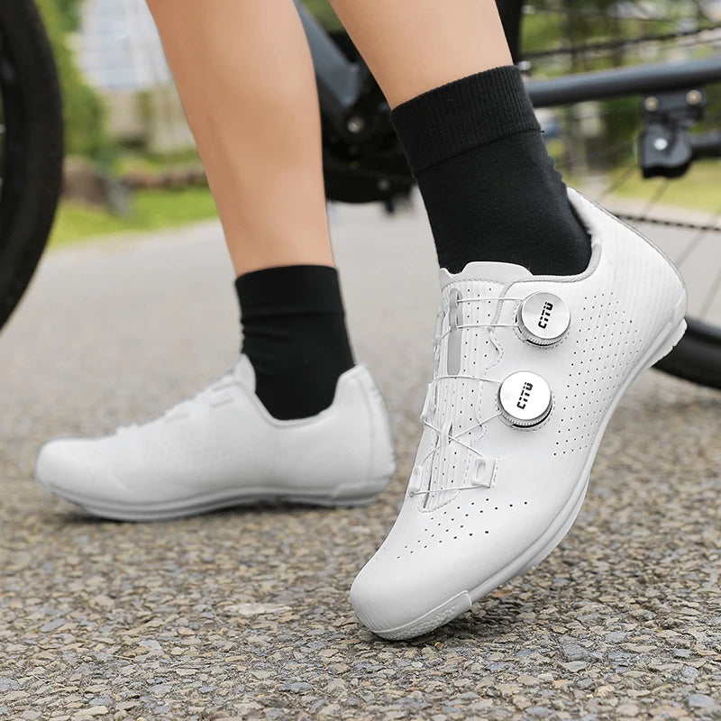 White sneakers with button details worn by a person on a blurred outdoor background