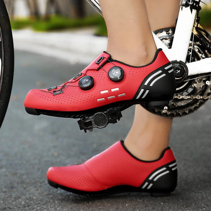 Red cycling shoes with black soles on a bike, on a road background