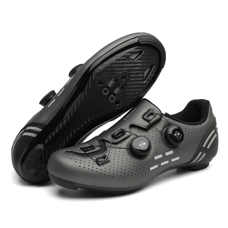 Black cycling shoes with a white sole on a white background