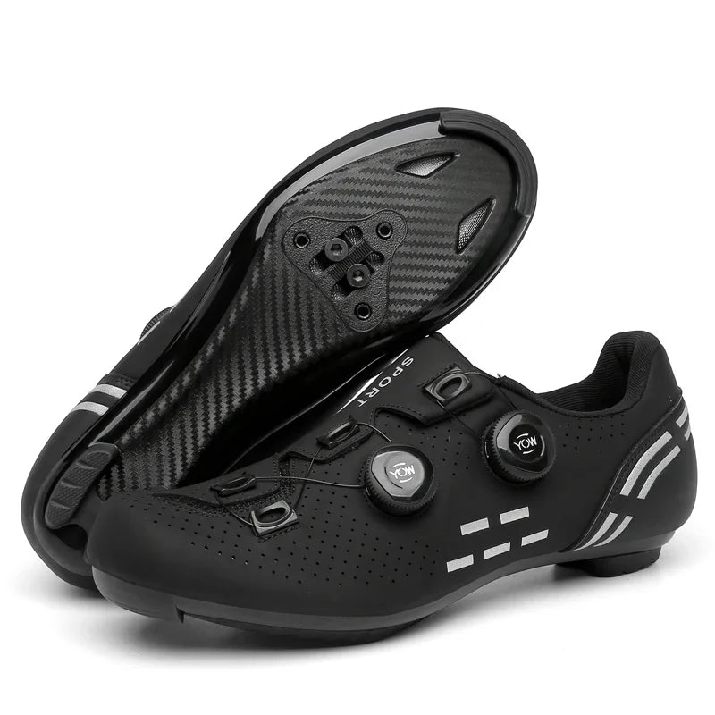 Black cycling shoes with carbon fiber sole on a white background