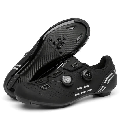 Black cycling shoes with carbon fiber sole on a white background