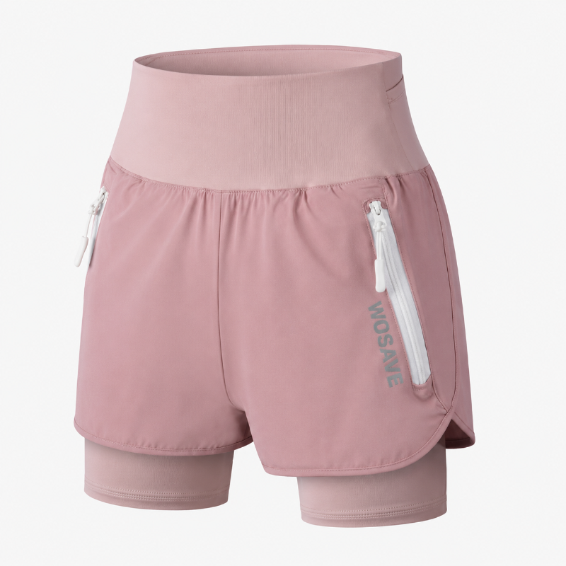 A pair of dusty pink double-layer running shorts with a zippered side pocket and a vertical 'WOSAVE' logo, shown on a light gray background.