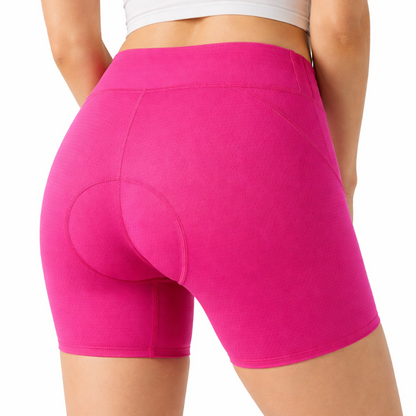 Person wearing bright pink athletic shorts on a white background