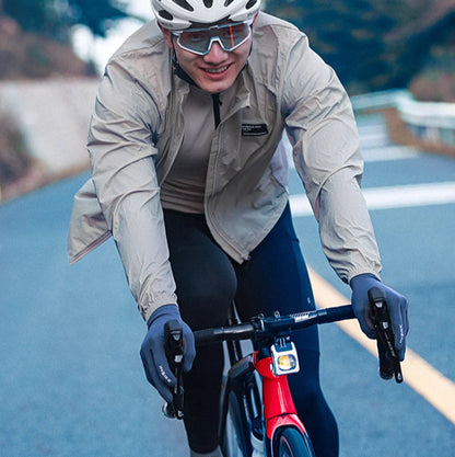 Model wearing blue windbreaker for road or mountain biking