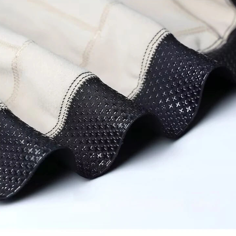 Close-up of black quilted jacket lining on a white background