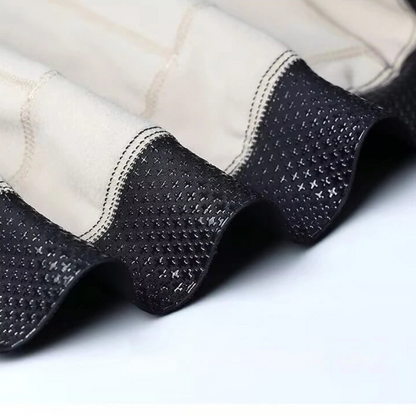 Close-up of black quilted jacket lining on a white background