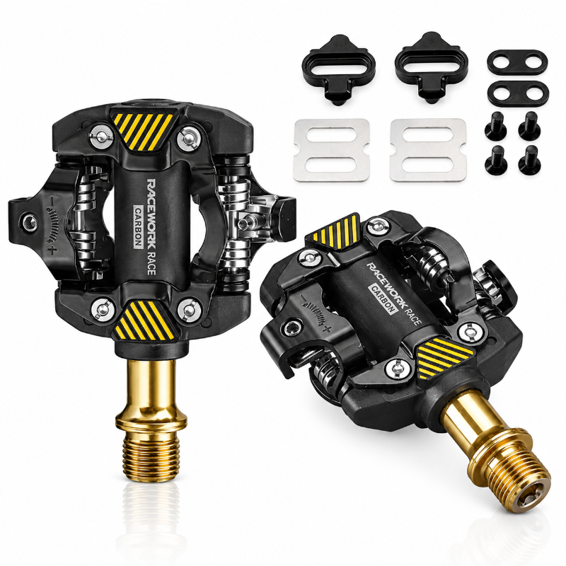 A pair of black and gold mountain bike carbon clip-on pedals shown on a clean white background, accompanied by mounting hardware.