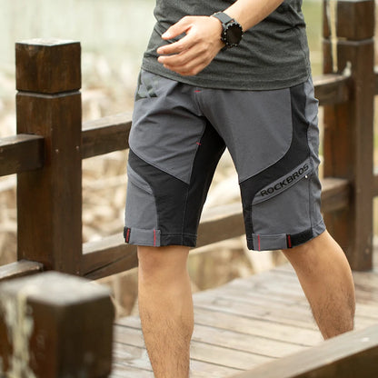 Person wearing gray and black shorts  on a wooden background