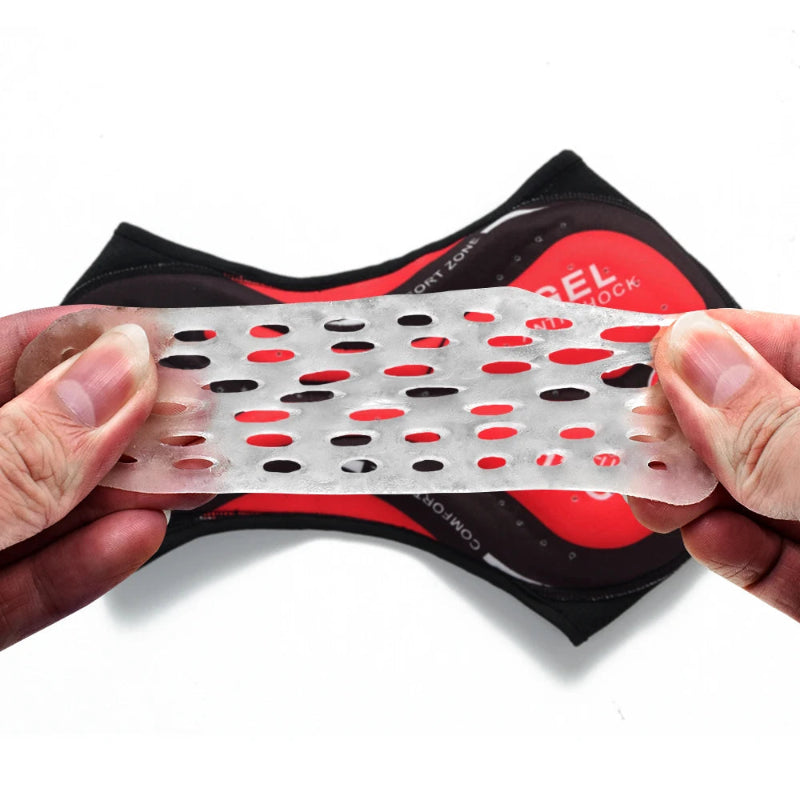 Clear silicone mat with red and black dots held by a hand, with packaging in the background.