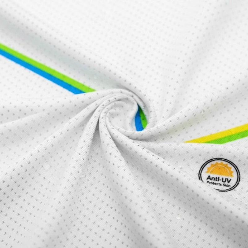 Close-up of a white fabric with green and blue accents and an Anti-UV logo.