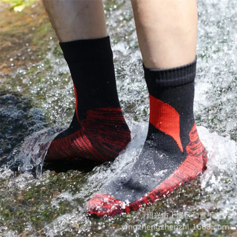 Black and red socks worn by a person standing in water