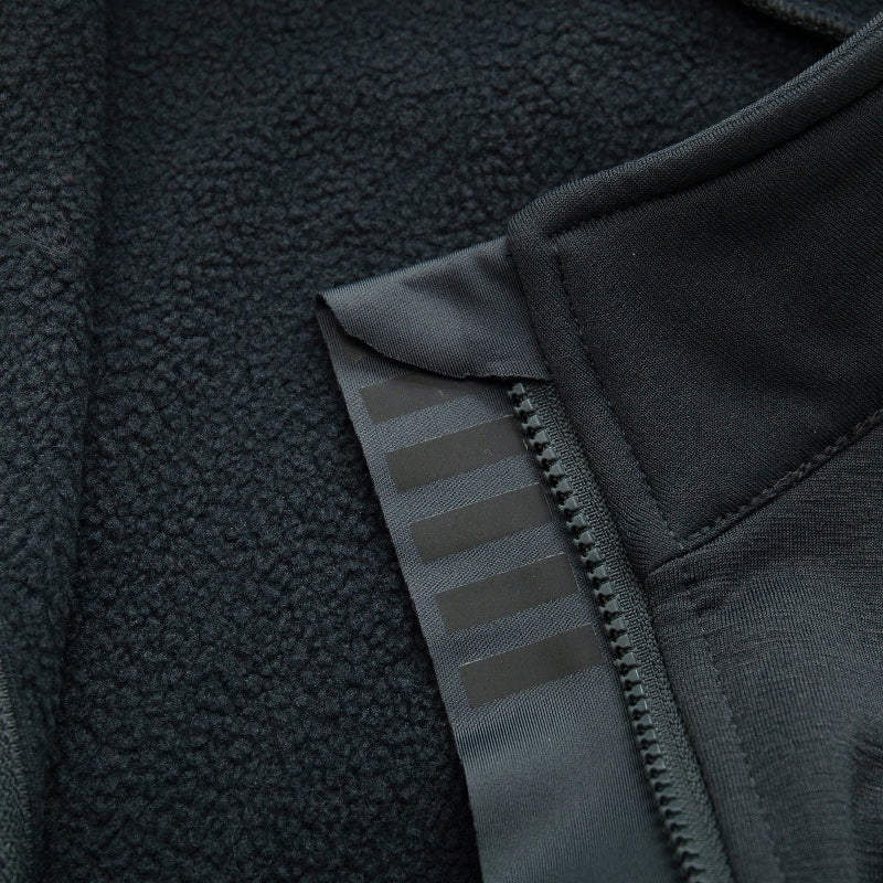 Close-up of a black fleece jacket with zipper and texture details