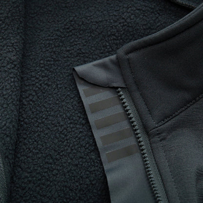 Close-up of a black fleece jacket with zipper and texture details