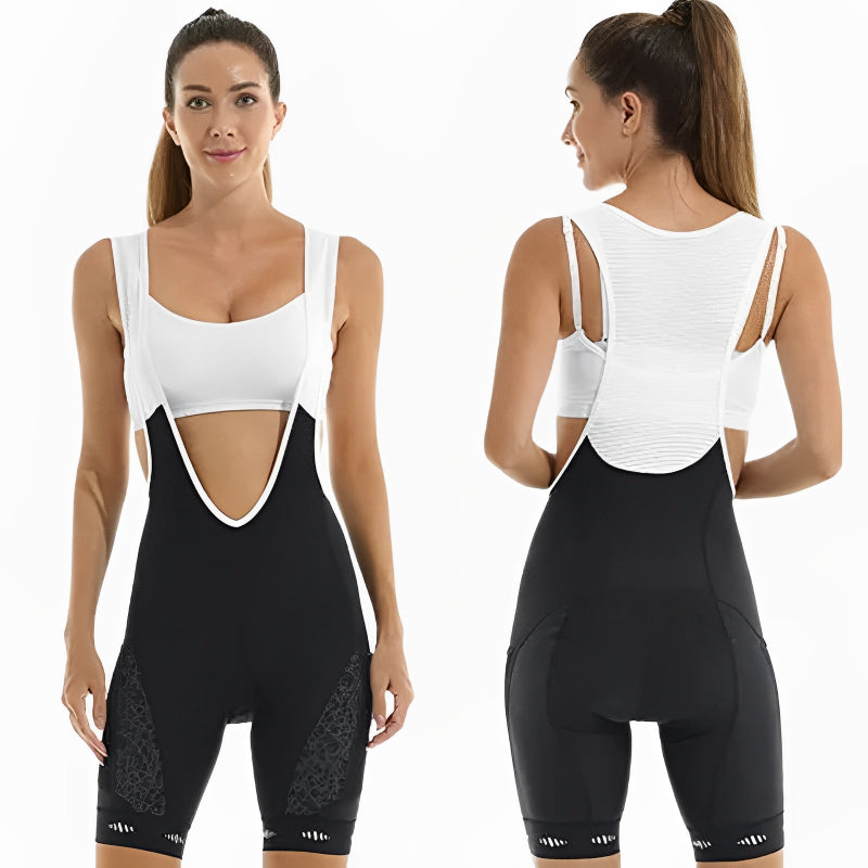 Woman wearing a black and white athletic outfit with cut-out design on a white background